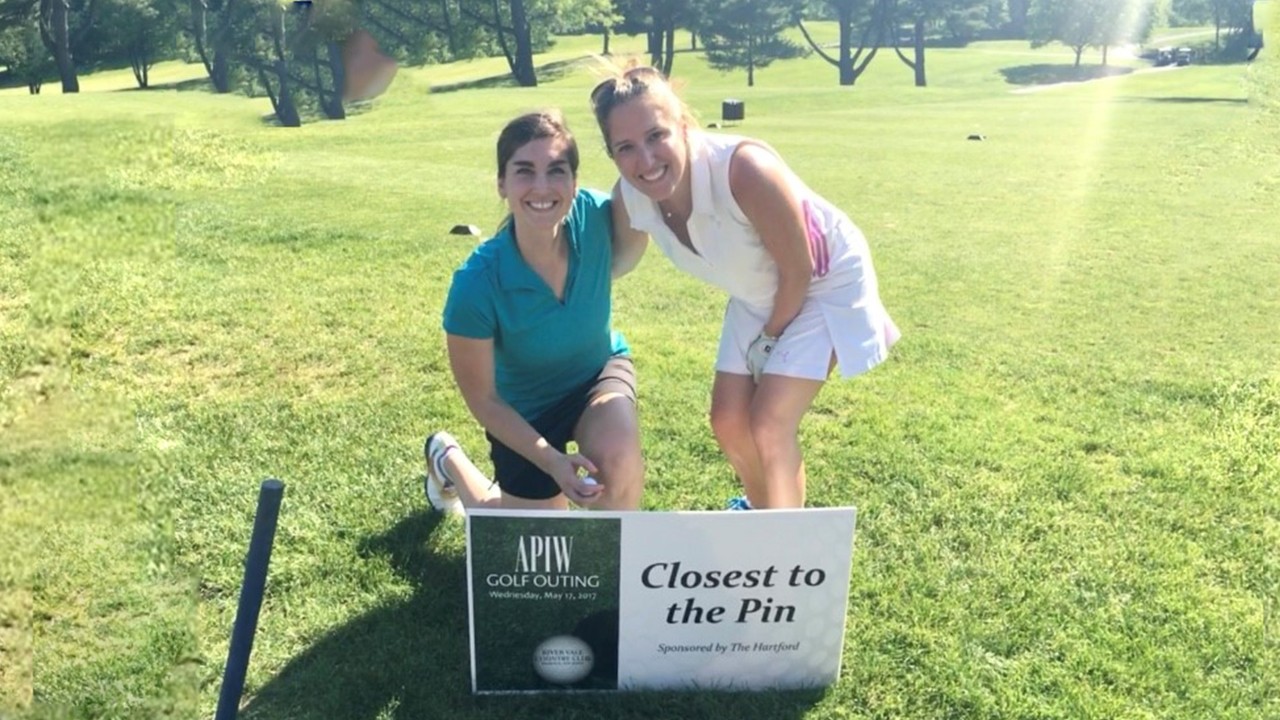 Carrie Kurzon and Meghan Marchica playing at an Association of Professional Insurance Women golf outing.